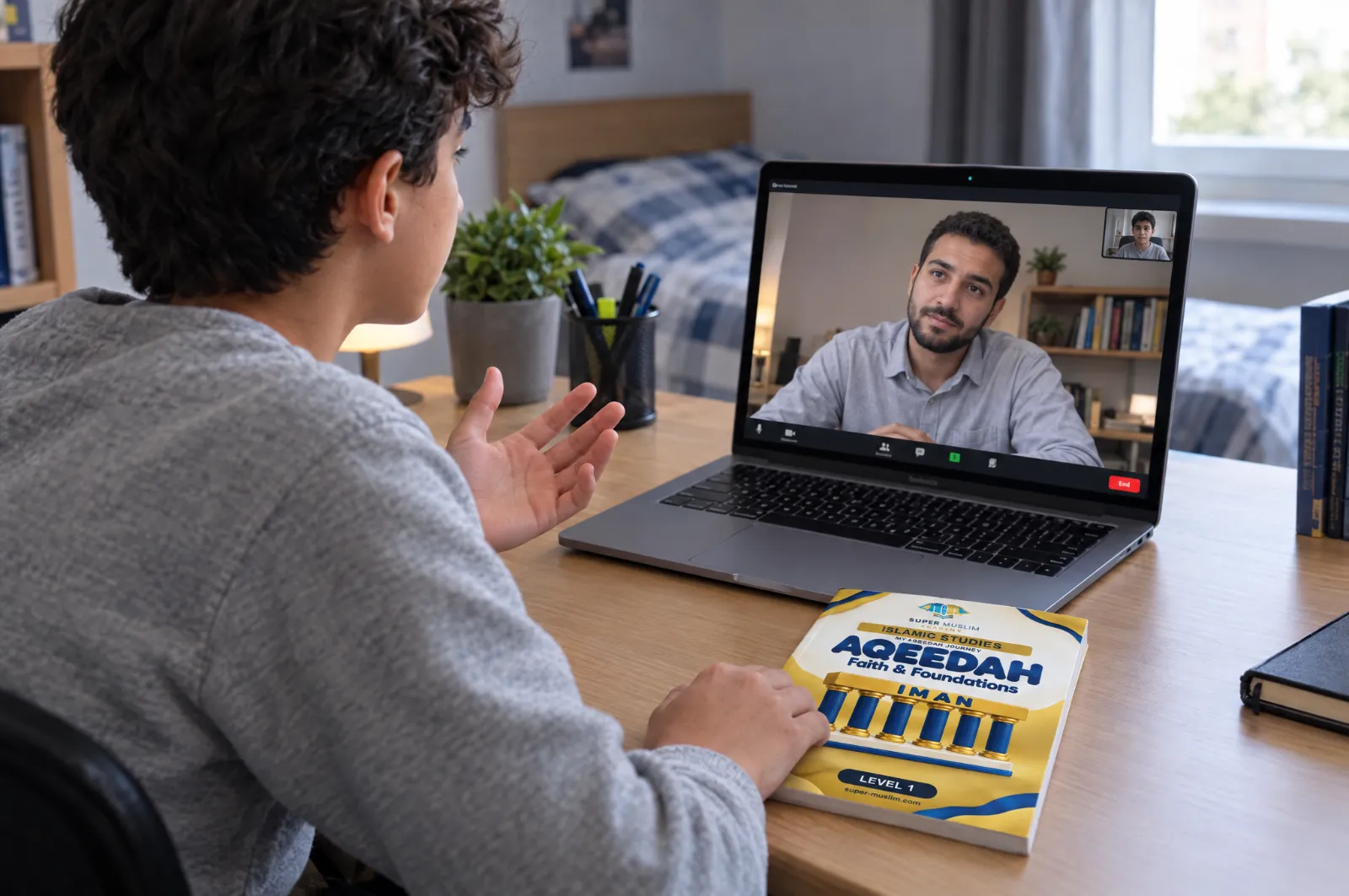 Boy asking his Egyptian Al-Azhar Islamic Studies teacher a question during a live online class on Zoom, with the Super Muslim Aqeedah Level 1 book on his desk